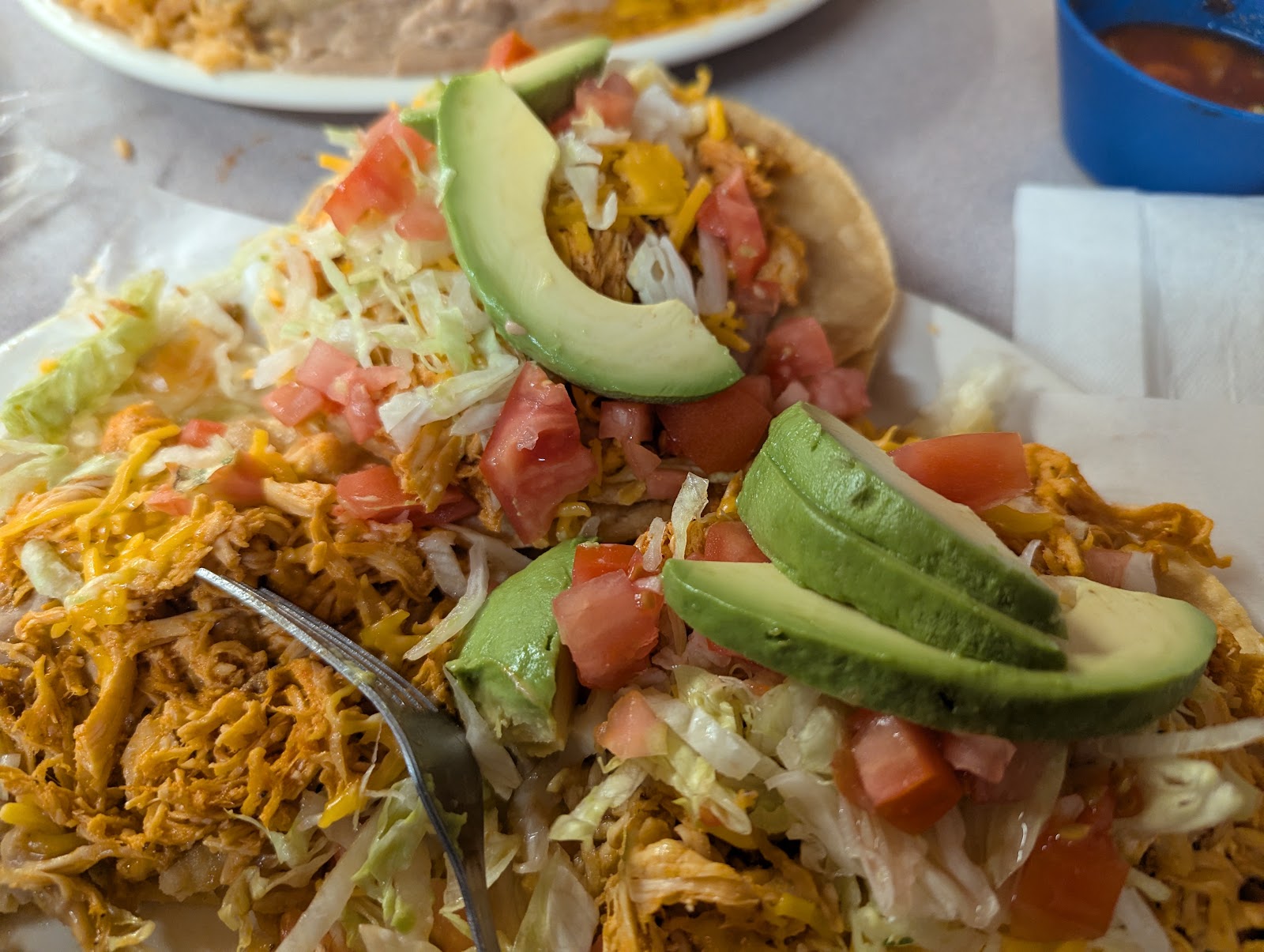 Chicken tostadas topped with fresh avocado