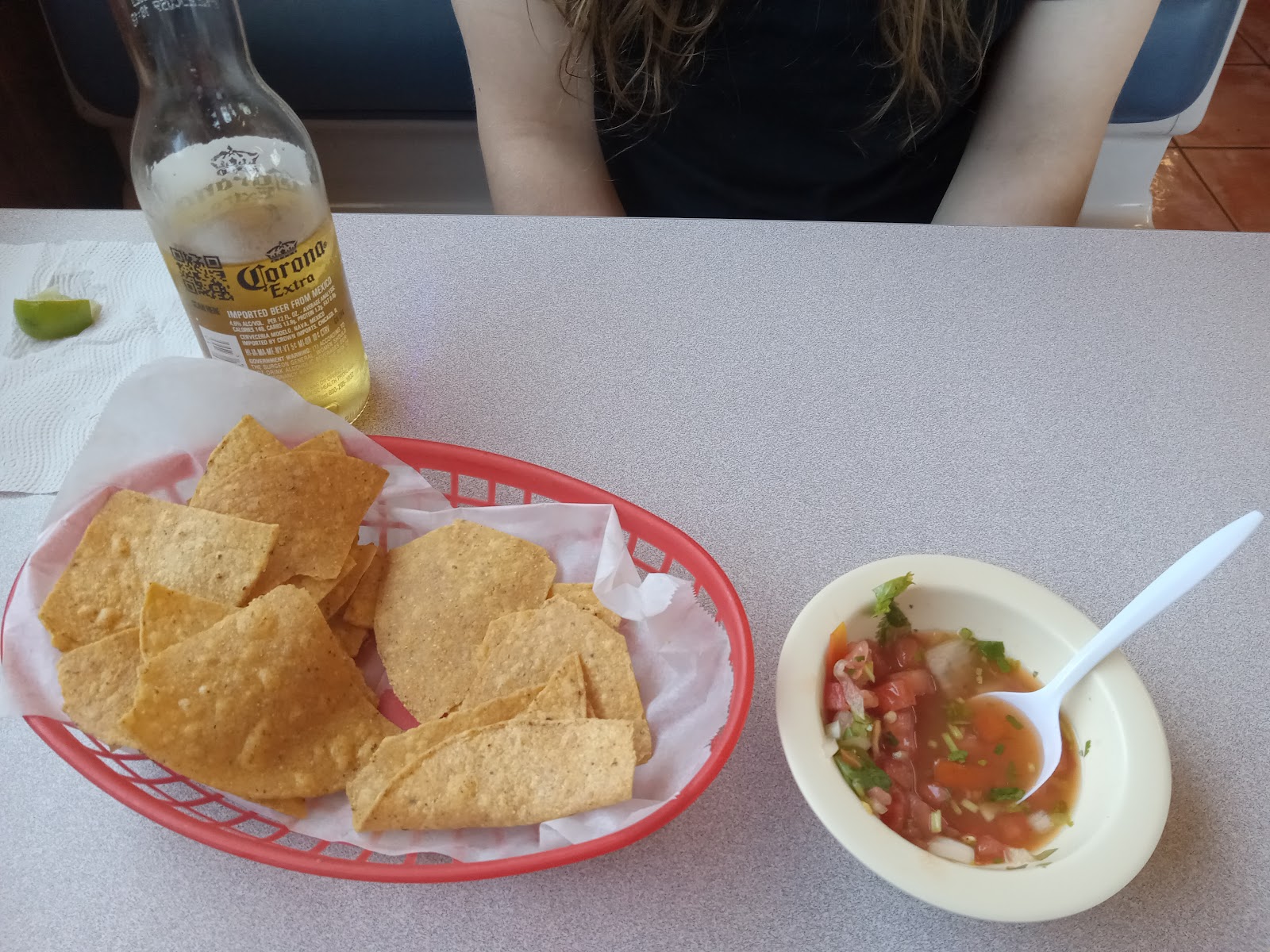 Chips and salsa served with a Corona beer